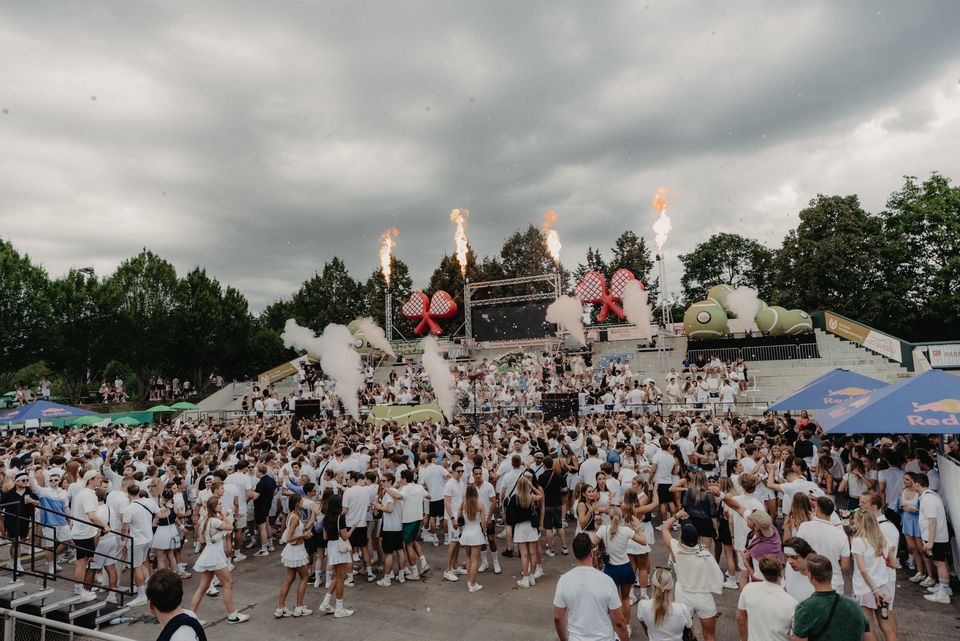 Der ganze Center Court voller Gäste in Weiß, Flammen über der Bühne mit Herzschlägern